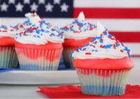 Three iced cupcakes with patriotic American designs of red, white, and blue.