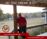 Dreaming Backside of man looking out over a large property.