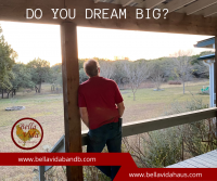 Backside of man looking out over a large property.