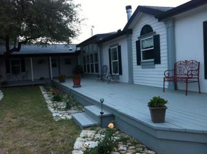 Fifty-foot long elevated front porch without a railing or cover.