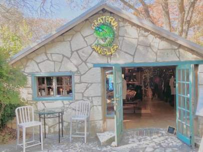 Grateful Angler Outside entrance to the store. It's a small, rustic, natural wood building.