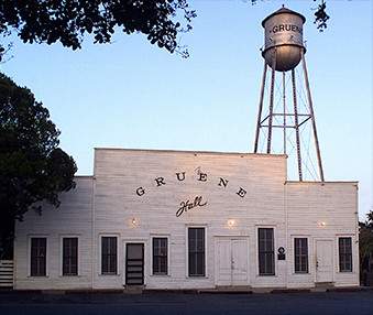 Historic old building of Gruene Hall with the Gruene water tower in the background.