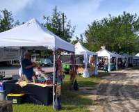 Row of white tents with local artisans set up for Gruene Market Days.