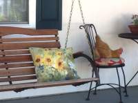 BellaVida hen laying an egg in a chair on the front porch.