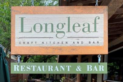 Engraved wooden sign that reads: Longleaf Craft Kitchen and Bar