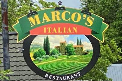 Colorful hanging sign of green, gold and orange: Marco's Italian Restaurant
