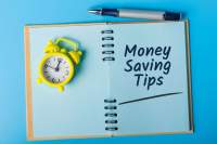Money Savings Tips Open journal with a note that reads