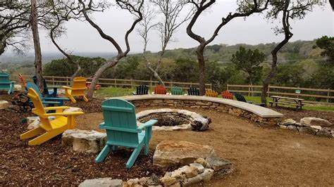 Colorful adirondack chair seating facing a Texas Hill Country view. 