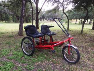 Red adult sized trike for two.
