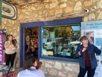 Author Wendy Hinote Lanier reads her latest book to a child and mother sitting outside of the Blue Willow store. 