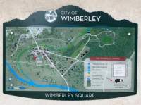 A Map of Wimberley Texas highlighting the area of the Wimberley Square. It indicates shops, parks, restaurants, parking areas and restrooms.