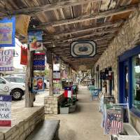 Shoppers stroll along the boutiques in the Wimberley Square.