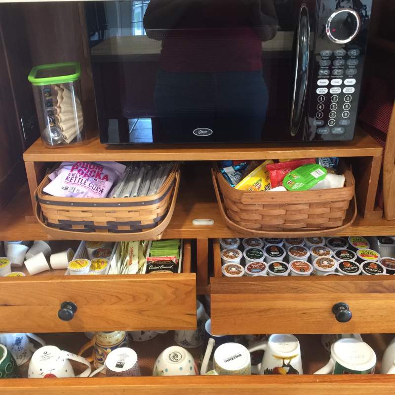 Coffee bar with k-cups of coffee,  other beverages, sweeteners and complimentary snack baskets.