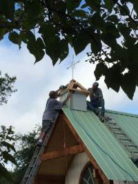 Cross is installed on the cupola, or chapel steeple.