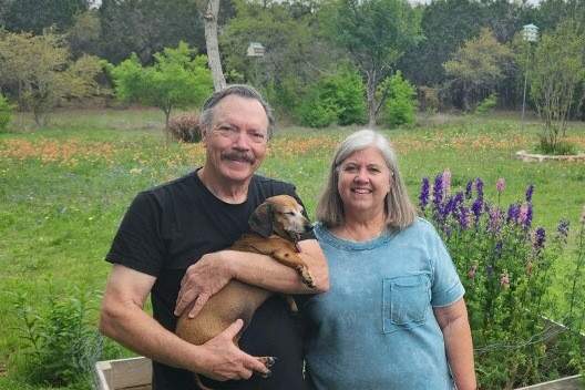Steve and Belinda Innkeepers -Our Story Steve is holding BellaVida Bed and Breakfast's resident dachshund, Gracie, with Steve's wife, Belinda at their side.